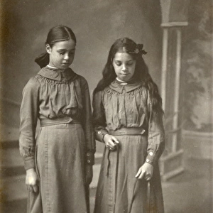 Studio portrait, two girls with terrier dog