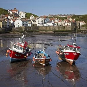 Fishing boats at low tide, Staithes, North Yorkshire, England