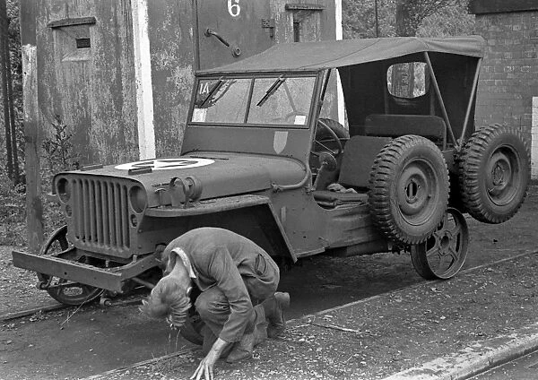 Man repairing a jeep