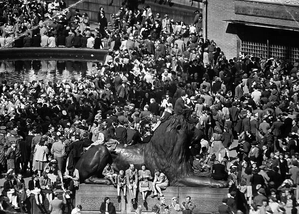 VJ Day. The crowd around the lion in Trafalgar Square listening to the dance music