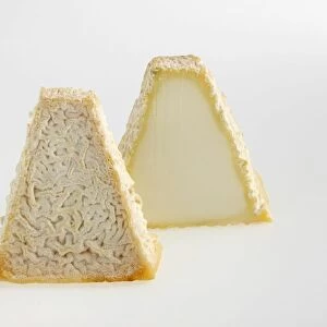 Sliced pyramid of French Pouligny-Saint-Pierre goats cheese with textured rind